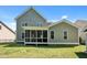 Home featuring a screened porch overlooking the lush green backyard at 208 Willowbend Ln, Hillsborough, NC 27278