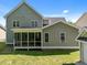Home featuring a screened porch overlooking the lush green backyard at 208 Willowbend Ln, Hillsborough, NC 27278