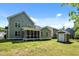 Home featuring a screened porch, storage building, and fenced yard at 208 Willowbend Ln, Hillsborough, NC 27278