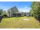 Home featuring a screened porch, storage building, and fenced yard at 208 Willowbend Ln, Hillsborough, NC 27278