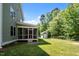 Home featuring a screened porch, storage building, and fenced yard at 208 Willowbend Ln, Hillsborough, NC 27278