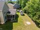 Aerial view of backyard with screened porch, storage shed, and playground at 208 Willowbend Ln, Hillsborough, NC 27278