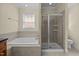 Bright bathroom featuring a soaking tub and walk-in shower at 208 Willowbend Ln, Hillsborough, NC 27278