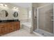 Bright bathroom featuring a double vanity, soaking tub and walk-in shower at 208 Willowbend Ln, Hillsborough, NC 27278