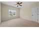 Neutral bedroom featuring neutral carpet, window, and a ceiling fan at 208 Willowbend Ln, Hillsborough, NC 27278