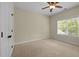 Neutral bedroom featuring neutral carpet, window, and a ceiling fan at 208 Willowbend Ln, Hillsborough, NC 27278