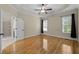 Spacious bedroom with hardwood floors, natural light, and an attached bathroom at 208 Willowbend Ln, Hillsborough, NC 27278