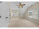 Spacious bedroom with plush carpet, a ceiling fan, and bright windows for natural light at 208 Willowbend Ln, Hillsborough, NC 27278