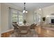 Cozy dining area with natural light and a view of the fireplace, perfect for Gathering meals at 208 Willowbend Ln, Hillsborough, NC 27278