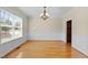 Elegant dining room with wainscoting, hardwood floors, and large window with natural light at 208 Willowbend Ln, Hillsborough, NC 27278
