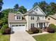 Charming two-story home with a well-manicured lawn and a two car garage at 208 Willowbend Ln, Hillsborough, NC 27278