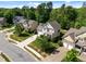 A charming two-story home with a manicured front yard, featuring light green siding and a covered front porch at 208 Willowbend Ln, Hillsborough, NC 27278