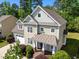 Charming two-story home with a well-manicured lawn and inviting front entrance at 208 Willowbend Ln, Hillsborough, NC 27278