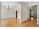 Open hallway showcasing hardwood floors and classic trim, leading to various rooms at 208 Willowbend Ln, Hillsborough, NC 27278