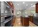 Modern kitchen featuring stainless steel appliances and a spacious island with granite countertops at 208 Willowbend Ln, Hillsborough, NC 27278