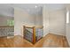 Second floor landing featuring hardwood floors, wood railing, and trim at 208 Willowbend Ln, Hillsborough, NC 27278