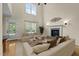 Bright living room with a soaring ceiling, fireplace, large window and hardwood floors at 208 Willowbend Ln, Hillsborough, NC 27278