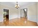 Spacious living room featuring hardwood floors, classic trim, and an open layout at 208 Willowbend Ln, Hillsborough, NC 27278