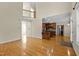 Spacious living room with hardwood floors offering a view of the kitchen with dark wood cabinets at 208 Willowbend Ln, Hillsborough, NC 27278