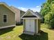 Storage building with double doors located in a well-maintained backyard at 208 Willowbend Ln, Hillsborough, NC 27278