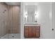 This luxurious bathroom features a glass enclosed shower and wood paneled vanity at 2104 Manuel St, Raleigh, NC 27612