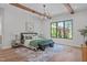 Bright bedroom featuring a large window, wood beams, stylish chandelier, and elegant decor at 2104 Manuel St, Raleigh, NC 27612