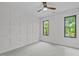 This bedroom features modern, geometric accent wall with two windows and a ceiling fan at 2104 Manuel St, Raleigh, NC 27612