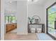 Bright entryway features sleek flooring, a decorative table and mirror, and views into the kitchen at 2104 Manuel St, Raleigh, NC 27612