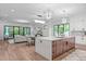 Open-concept kitchen flows into the living and dining areas, featuring a spacious island at 2104 Manuel St, Raleigh, NC 27612