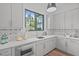 Modern kitchen with gray cabinetry, geometric backsplash, stainless appliances and natural light at 2104 Manuel St, Raleigh, NC 27612