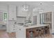 Kitchen showcases large island, designer lighting, stainless appliances, and adjacent wine storage at 2104 Manuel St, Raleigh, NC 27612