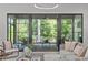 Open living room with sliding glass doors that lead to a patio with views of lush green trees at 2104 Manuel St, Raleigh, NC 27612