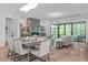 Open floorplan with a fireplace, dining table, and access to a living space filled with natural light at 2104 Manuel St, Raleigh, NC 27612
