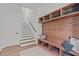 Convenient mudroom with hooks, shelves, and a bench for storage, bags, and coats near the stairs at 2104 Manuel St, Raleigh, NC 27612