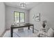 Well-lit home office with a modern desk, comfortable chair, stylish decor, and a large window at 2104 Manuel St, Raleigh, NC 27612