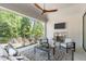 This screened-in patio features a fireplace, ceiling fan, and comfortable seating at 2104 Manuel St, Raleigh, NC 27612