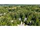 Aerial view of the property nestled in a lush, wooded setting, showcasing its privacy at 215 Hopesworth Ct, Hillsborough, NC 27278