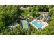 Stunning aerial view of community amenities including pool, tennis court, playground, and clubhouse at 215 Hopesworth Ct, Hillsborough, NC 27278