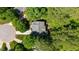 Aerial view of the house showing the roof and landscaping, nestled among green trees at 215 Hopesworth Ct, Hillsborough, NC 27278