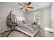 This bedroom features neutral walls, a ceiling fan, and a hanging chair at 215 Hopesworth Ct, Hillsborough, NC 27278