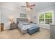 This bedroom boasts neutral walls, a ceiling fan, and a large window at 215 Hopesworth Ct, Hillsborough, NC 27278