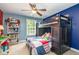 Colorful bedroom with a bunk bed, blue accent wall, and a ceiling fan at 215 Hopesworth Ct, Hillsborough, NC 27278