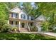 Charming home with a welcoming front porch, stone accents, and lush landscaping at 215 Hopesworth Ct, Hillsborough, NC 27278