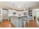 Bright kitchen featuring a breakfast bar, modern appliances, and ample cabinet space at 215 Hopesworth Ct, Hillsborough, NC 27278