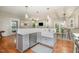 Kitchen island with a farmhouse sink, dishwasher, and breakfast bar with stylish seating at 215 Hopesworth Ct, Hillsborough, NC 27278