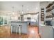 Open kitchen with modern appliances, breakfast bar, and stylish pendant lighting at 215 Hopesworth Ct, Hillsborough, NC 27278
