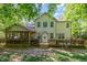 Rear exterior view of the home showcasing the deck, screened porch, and backyard at 215 Hopesworth Ct, Hillsborough, NC 27278