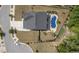 Aerial view of the property featuring a well-manicured yard, sparkling pool, and spacious patio area at 221 Obsidian Dr, Holly Springs, NC 27540