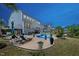 Backyard patio featuring lounge chairs, a dining area and a swimming pool at 221 Obsidian Dr, Holly Springs, NC 27540