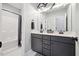 Bathroom featuring a double sink vanity with grey cabinets and a shower and tub combo at 221 Obsidian Dr, Holly Springs, NC 27540